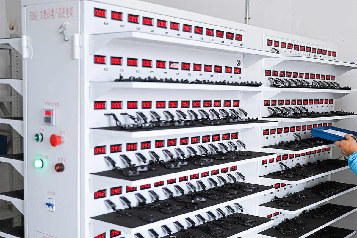 Aging and charging rack with hundreds of wearable units under test